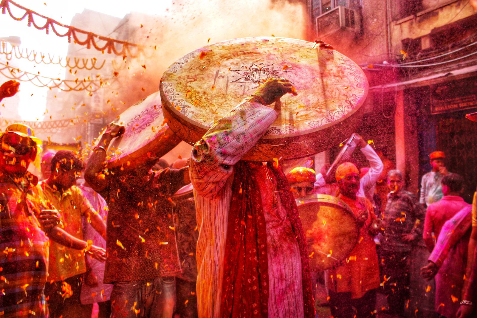 Colored powder thrown over the crowd at a Holi festival