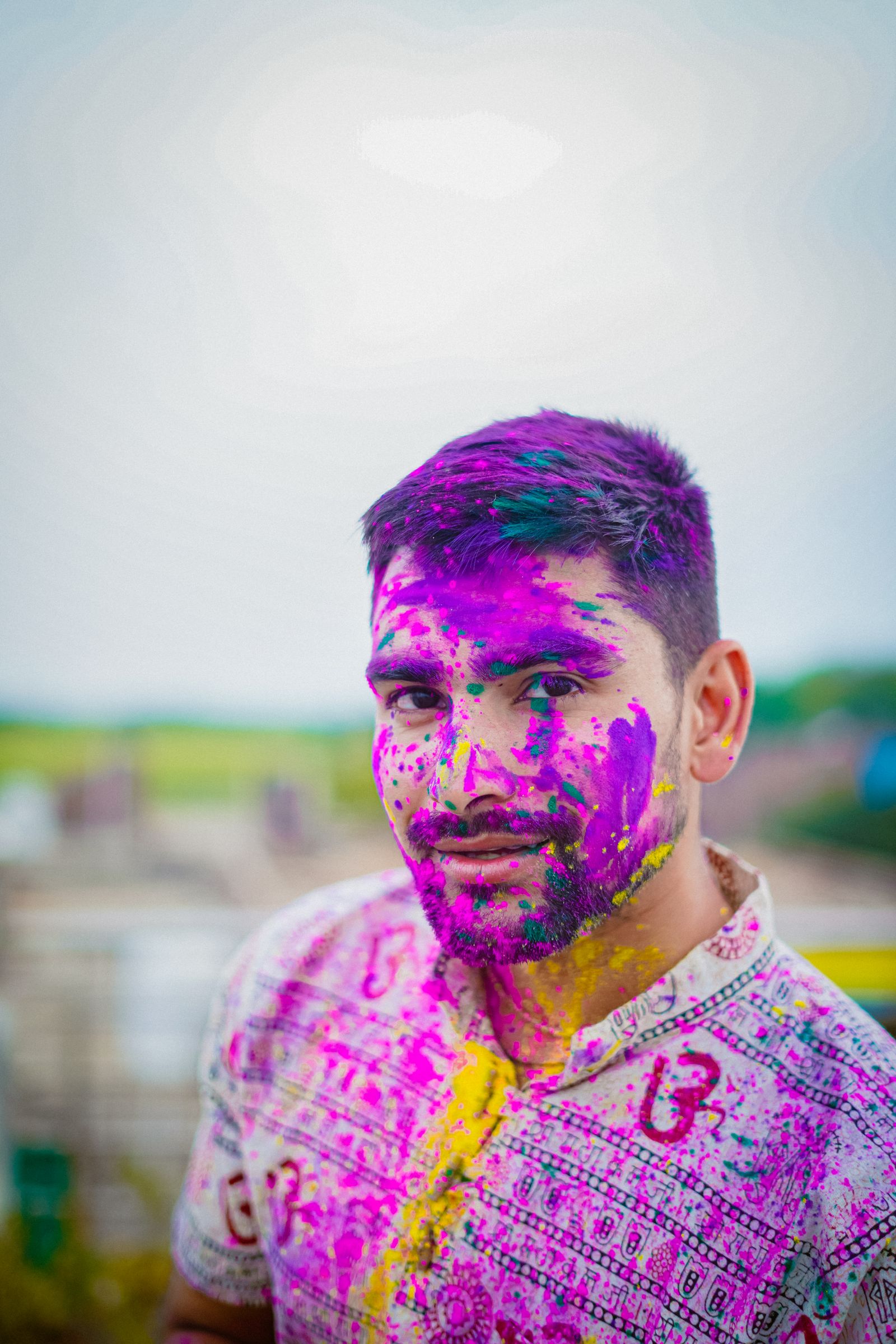 AI face recognition scanning a color-covered face at a Holi festival