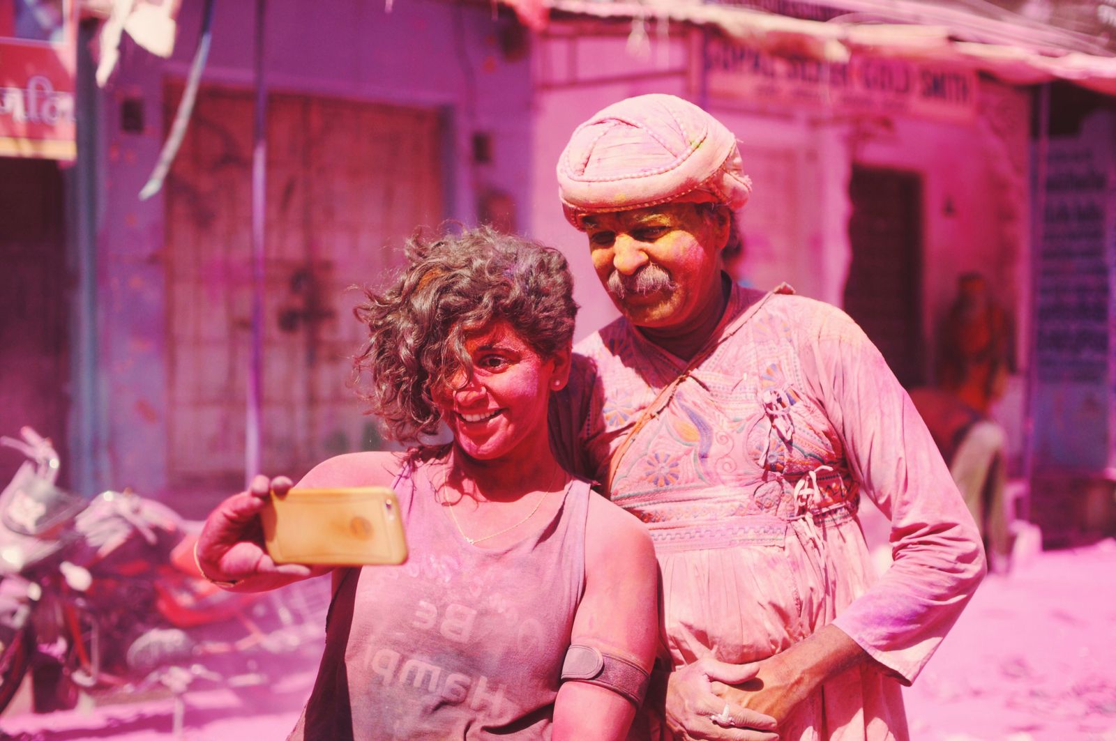 Friends taking a selfie to instantly find their Holi event photos