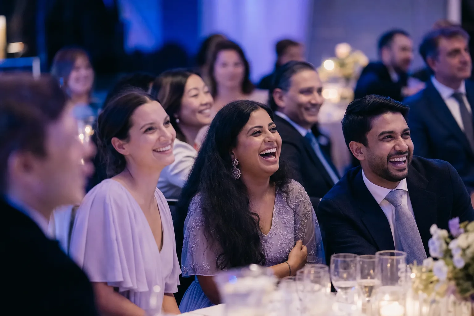 Guests laughing together at a formal event dinner